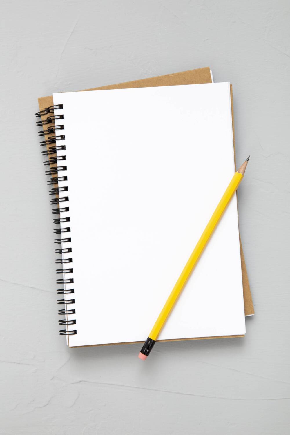 carnet ouvert sur page blanche avec crayon jaune